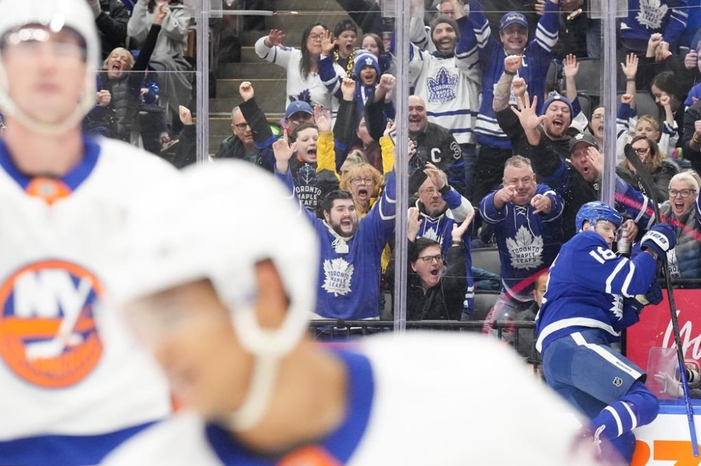 Maple Leafs forward Steven Lorentz (18) celebrates against the glass after scoring his team's second goal against the New York Islanders during second-period NHL action in Toronto on Tuesday, December 31, 2024. THE CANADIAN PRESS/Chris Young