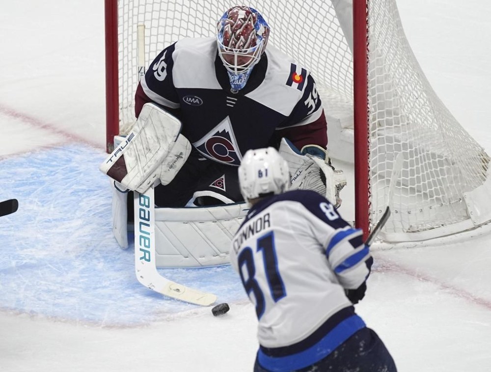 Winnipeg Jets left wing Kyle Connor (81) shoots against Colorado Avalanche goaltender Mackenzie Blackwood (39) in the third period of an NHL hockey game Tuesday, Dec. 31, 2024, in Denver. (AP Photo/David Zalubowski)