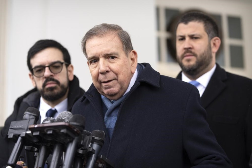 Venezuela's opposition leader Edmundo Gonzalez, center, speaks with reporters at the White House, Monday, Jan. 6, 2025, in Washington. (AP Photo/Mark Schiefelbein)