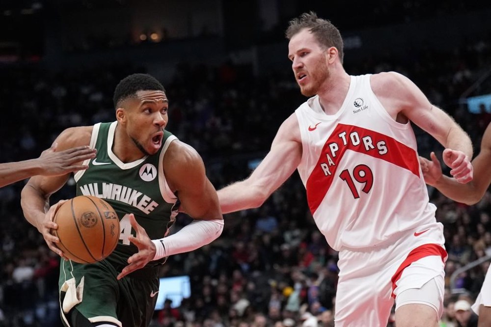 Milwaukee Bucks forward Giannis Antetokounmpo (34) drives past Toronto Raptors centre Jakob Poeltl (19) during second half NBA basketball action in Toronto, Monday, Jan. 6, 2025. THE CANADIAN PRESS/Nathan Denette