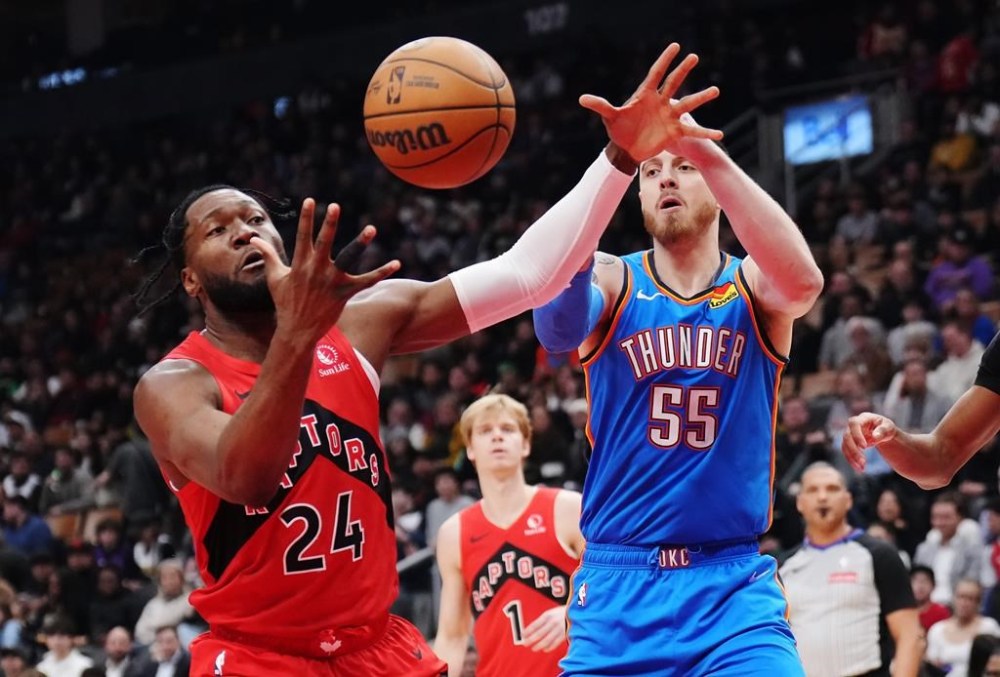 Toronto Raptors' centre Bruno Fernando (24) is fouled by Oklahoma City Thunder's Isaiah Hartenstein (55) during first half NBA action in Toronto on Thursday, Dec. 5, 2024. The Raptors have waived Fernando, the NBA team announced Tuesday. THE CANADIAN PRESS/Nathan Denette