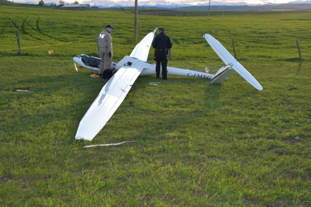 A TSB investigator and RCMP constable are shown at the scene of a fatal glider accident near the Black Diamond / Cu Nim Airport northeast of Diamond Valley, Alta., in this May 29, 2024 handout photo. THE CANADIAN PRESS/HO - Transportation Safety Board of Canada