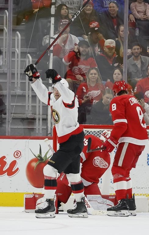 Ottawa Senators center Josh Norris (9) celebrates a goal scored by Brady Tkachuk against Detroit Red Wings goaltender Cam Talbot (39) as defenseman Ben Chiarot (8) skates off during the second period of an NHL hockey game Tuesday, Jan. 7, 2025, in Detroit. (AP Photo/Duane Burleson)