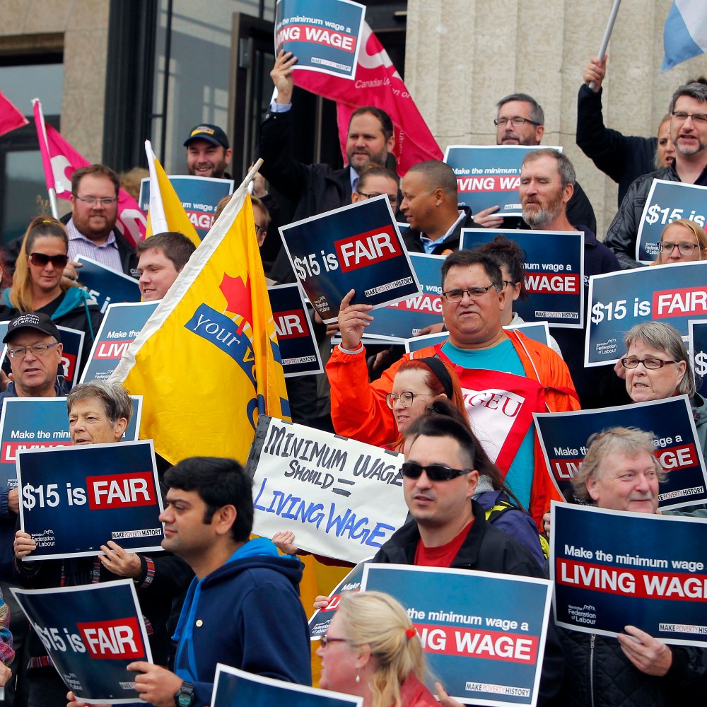 Protesters from Make Poverty History Manitoba and the Manitoba Federation of Labour are seen in this file photo from September 2017. They were hosting a community rally on the steps of the Manitoba Legislature building, calling on the provincial government to make the minimum wage a living wage at $15-an-hour. (Winnipeg Free Press)