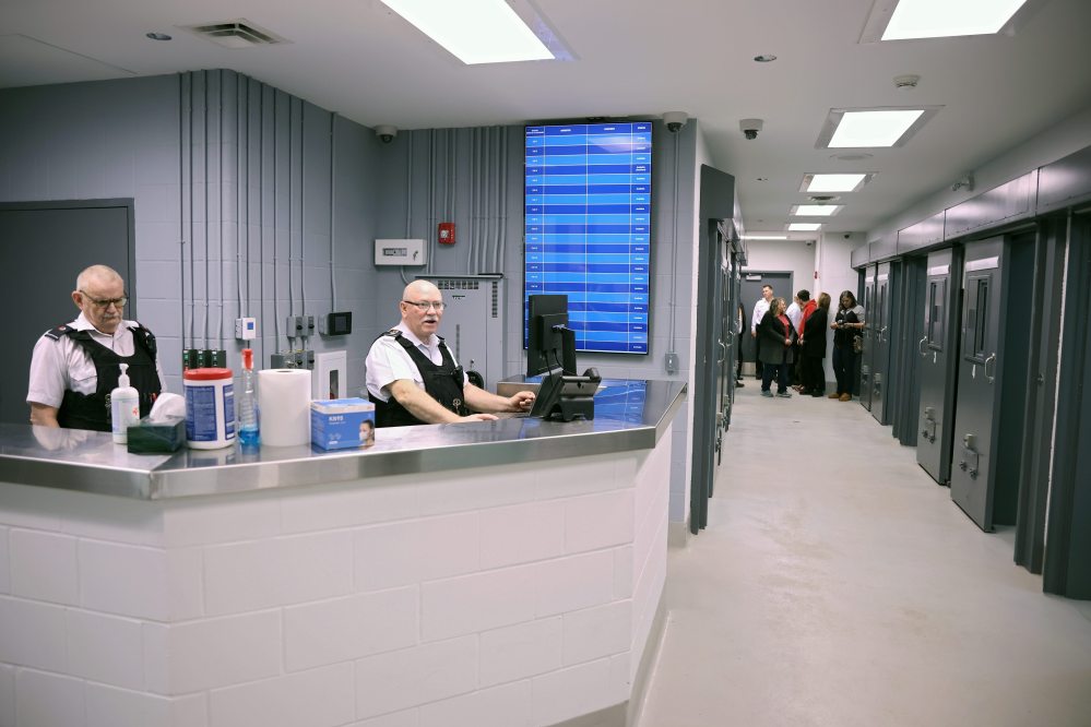 Commissioner Robert McKinnon and Warrant Officer Wade Gabriel work at the monitoring station in the new detention cell area at the Brandon Police Service headquarters in Brandon during a tour of the cells on Thursday. (Tim Smith/The Brandon Sun)