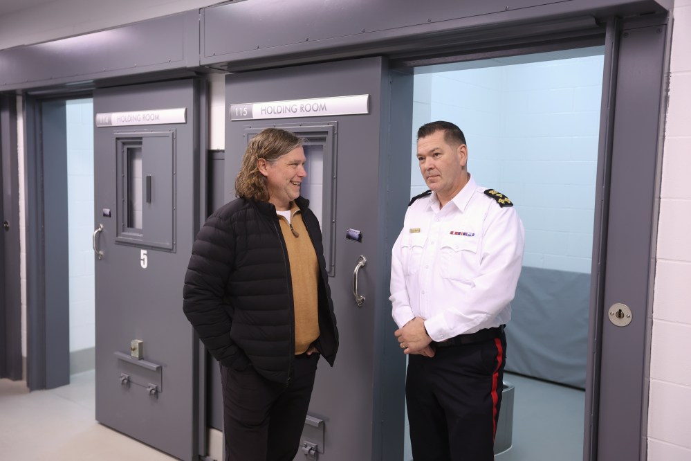 Brandon Mayor Jeff Fawcett (left) chats with Brandon Police Service Chief Tyler Bates while touring the new detention cells at BPS headquarters on Thursday. (Tim Smith/The Brandon Sun)