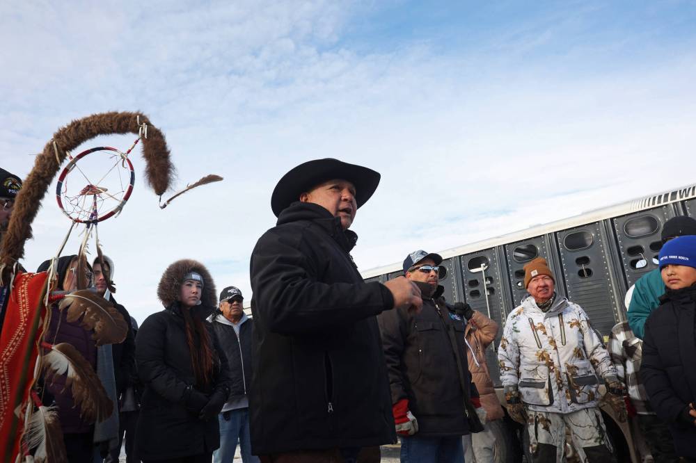 Travis Mazawasicuna with the Sioux Valley Unity Riders speaks to students from Birdtail Sioux First Nation prior to the riders escorting the bison through Birdtail to their new home on Tuesday. Mazawasicuna spoke about the spiritual and cultural importance of the bison. (Tim Smith/The Brandon Sun)