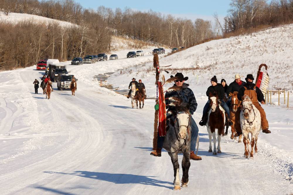 Sioux Valley Dakota Nation Unity Riders and riders from Birdtail Sioux First Nation lead the way to escort 11 bison (often referred to as buffalo in Dakota culture) through Birdtail to their new home in an enclosure in the First Nation’s river valley on Tuesday. (Tim Smith/The Brandon Sun)
