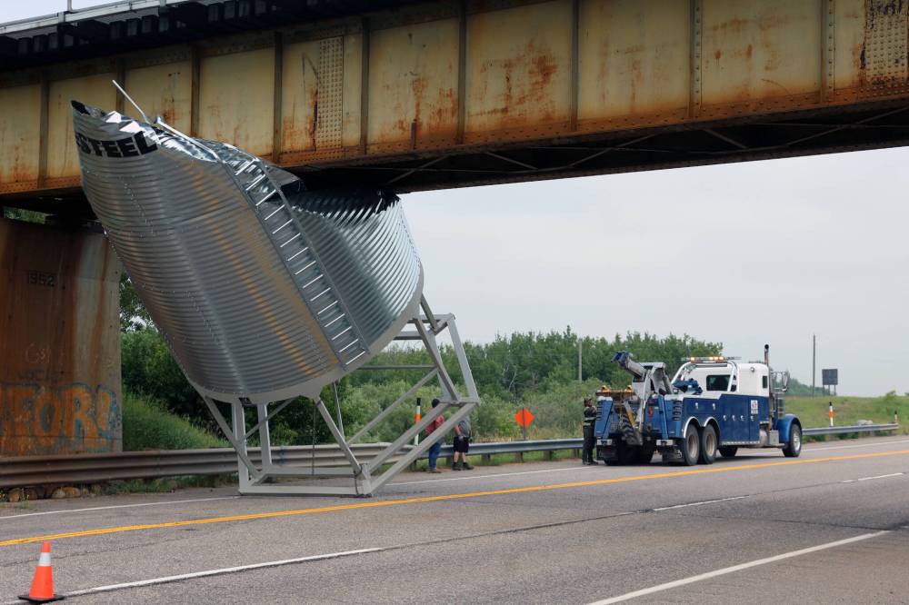 A grain bin carried by a Heritage Co-op truck got stuck under a CN Rail overpass in July, requiring the use of a tow truck to extricate it. The incident happened on Highway 10, about 10 kilometres north of Brandon Municipal Airport. (Colin Slark/The Brandon Sun)