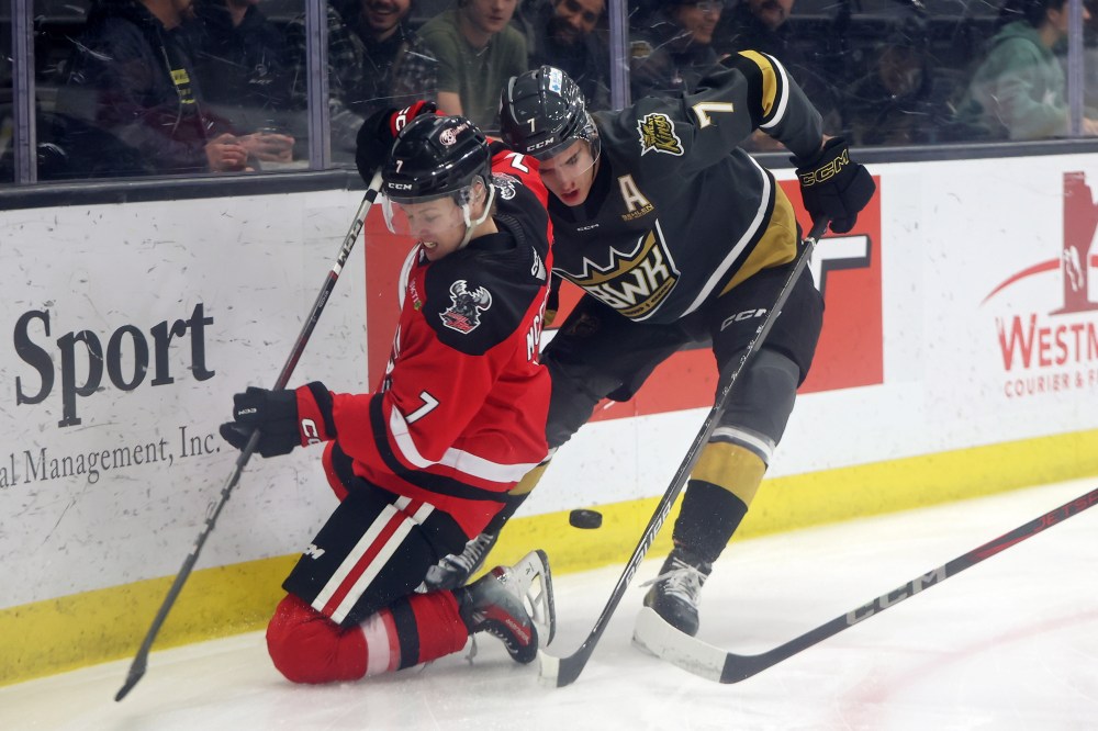 Charlie Elick of the Brandon Wheat Kings battles for the puck against Landen McFadden of the Moose Jaw Warriors during WHL action at Westoba Place on Tuesday evening.(Tim Smith/The Brandon Sun)