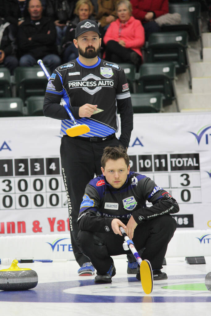 Skip Reid Carruthers of the West St. Paul Curling Club looks over the shoulder of a crouched Jason Gunnlaugson of the Granite Curling Club the last time a Viterra Championship was held in Stride Place in Portage la Prairie back in 2017. (Nathan Liewicki/The Brandon Sun)