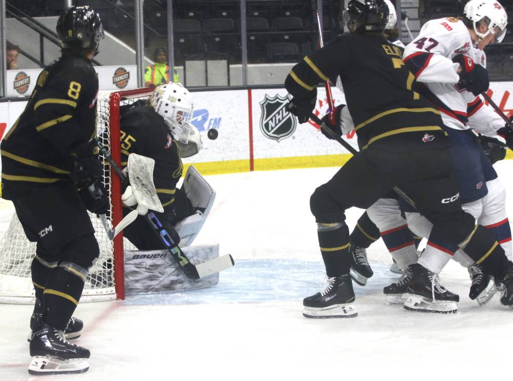 Brandon Wheat Kings rookie goaltender Dylan McFadyen (35) tries to cover the net as the puck flutters over his shoulder for the opening goal during Western Hockey League action at Westoba Place on Friday. Brandon defencemen Quinn Mantei (8) and Charlie Elick (7) plus Regina Pats forward Cameron Kuzmna (47) are also watching the play. (Perry Bergson/The Brandon Sun)