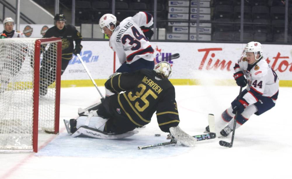 Brandon Wheat Kings rookie goaltender Dylan McFadyen (35) makes a save on Regina Pats forward Zach Pantelakis (34) as defenceman Matt Paranych (44) looks for a rebound during Western Hockey League action at Westoba Place on Friday. (Perry Bergson/The Brandon Sun)