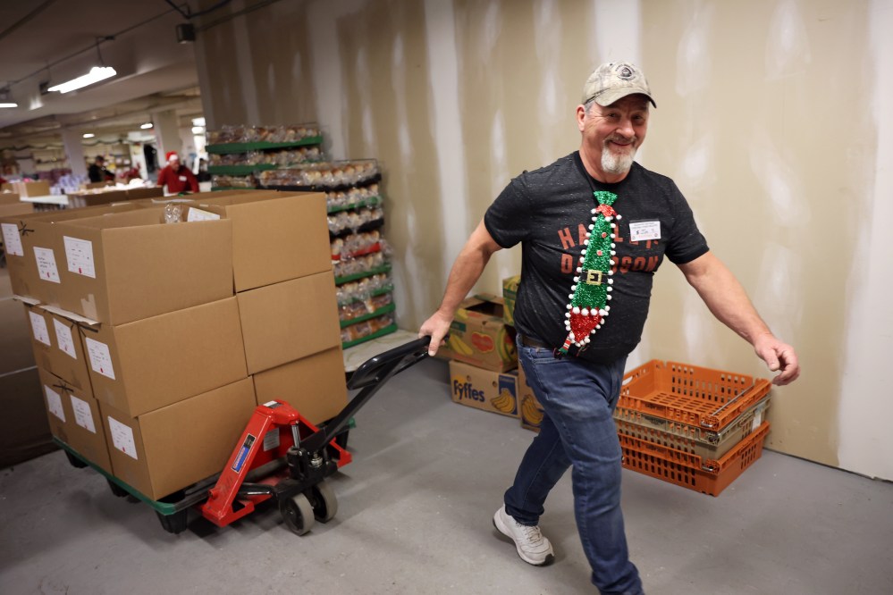 Jim Saltesz moves a pallet loaded with Christmas hampers through the warehouse on Wednesday.