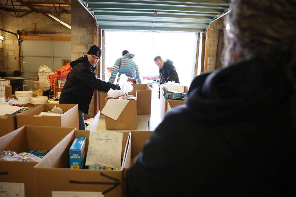 Volunteers help organize and move Christmas hampers through the Brandon-Westman Christmas Cheer warehouse to waiting vehicles.