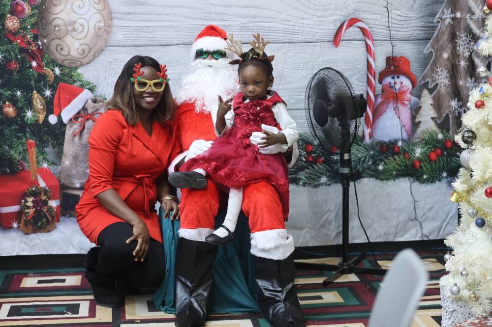 Christianah Ayanniyi (left), Santa Claus and Thelma Ayanniyi pose for a photo during the 2024 Christmas celebration organized by The Redeemed Christian Church of God Restoration Parish for children. (Photos by Abiola Odutola/The Brandon Sun)