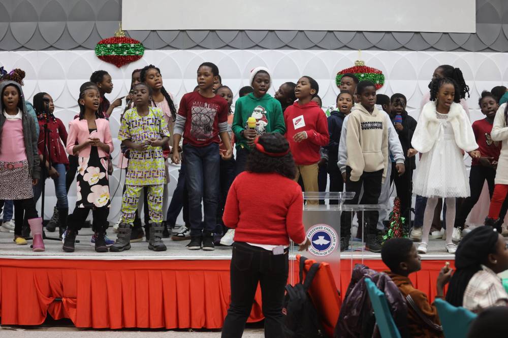 Members sing special songs during the 2024 Christmas celebration organized by The Redeemed Christian Church of God Restoration Parish for children.