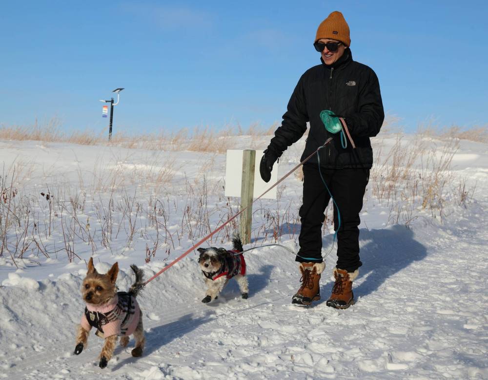 Colleen Lacey walks her two dogs, Rusty and Lacie, on the groomed trails.