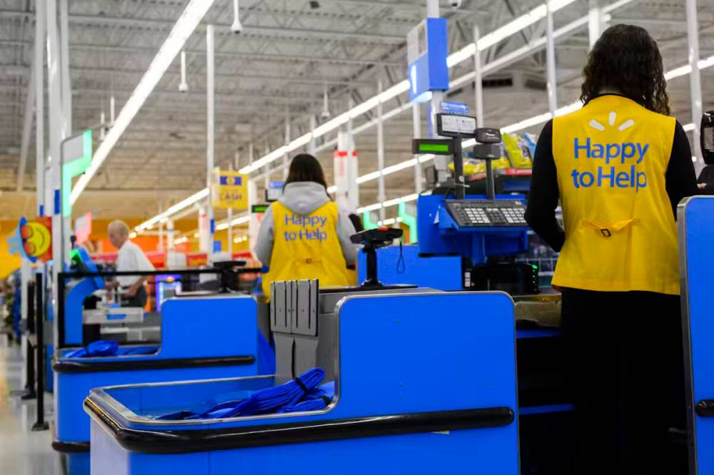 Employees are seen working at a Walmart in Vaughan, Ont. on July 2. Walmart is among those companies that have withdrawn from equity, diversity and inclusion initiatives due to political pressure. (The Canadian Press)