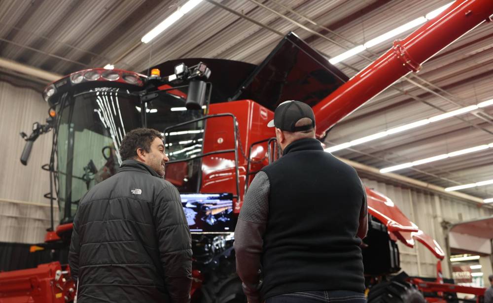 Sheldon Neufeld with Ens Quality Seed from Winkler, MB., listens to Chad Foster with Case IH as he talks about the features on the new Case IH combine at last year’s Manitoba Ag Days. (File)