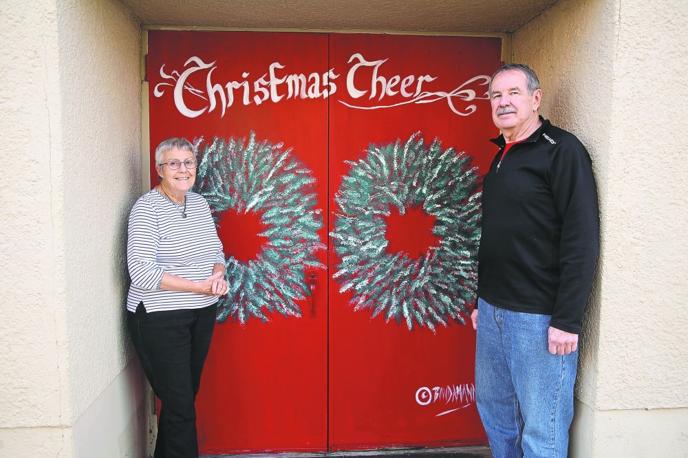 Brandon Christmas Cheer president Myrna Lane (left) and treasurer Bob Walberg (right) show off the mural local artist Anne Boychuk painted on the organization's front doors. The organization describes a $25,000 grant from the Manitoba government as a “welcome surprise.” (File)