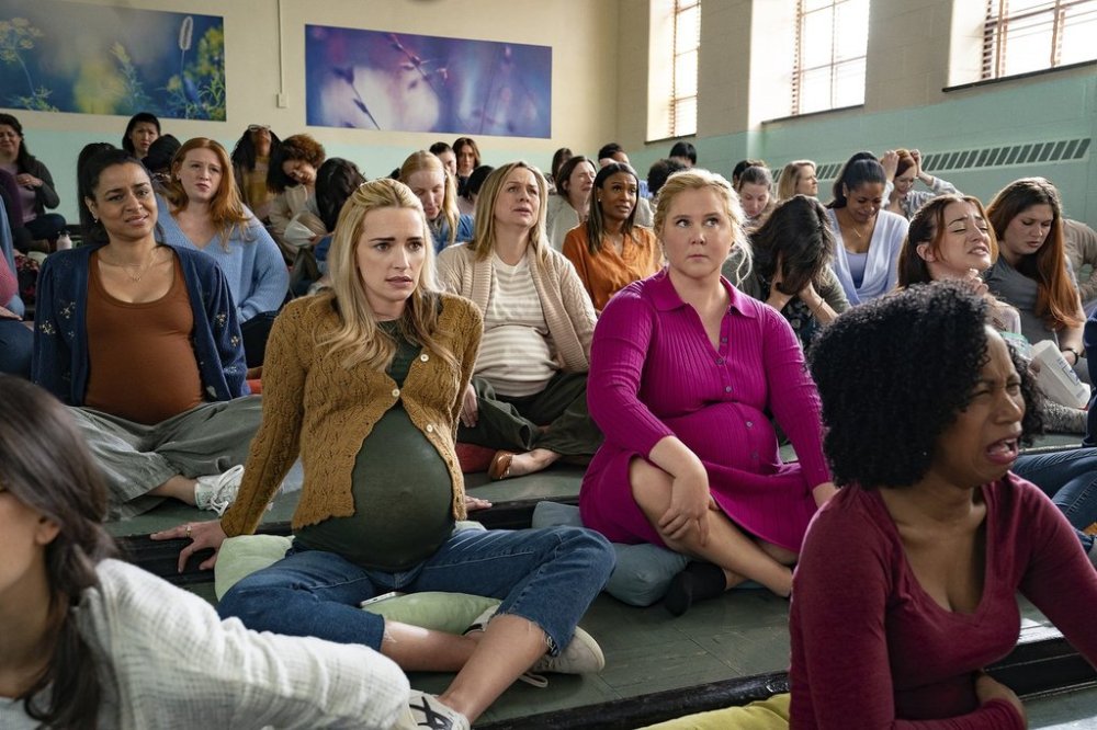 This image released by Netflix shows Brianne Howey, left, and Amy Schumer n a scene from