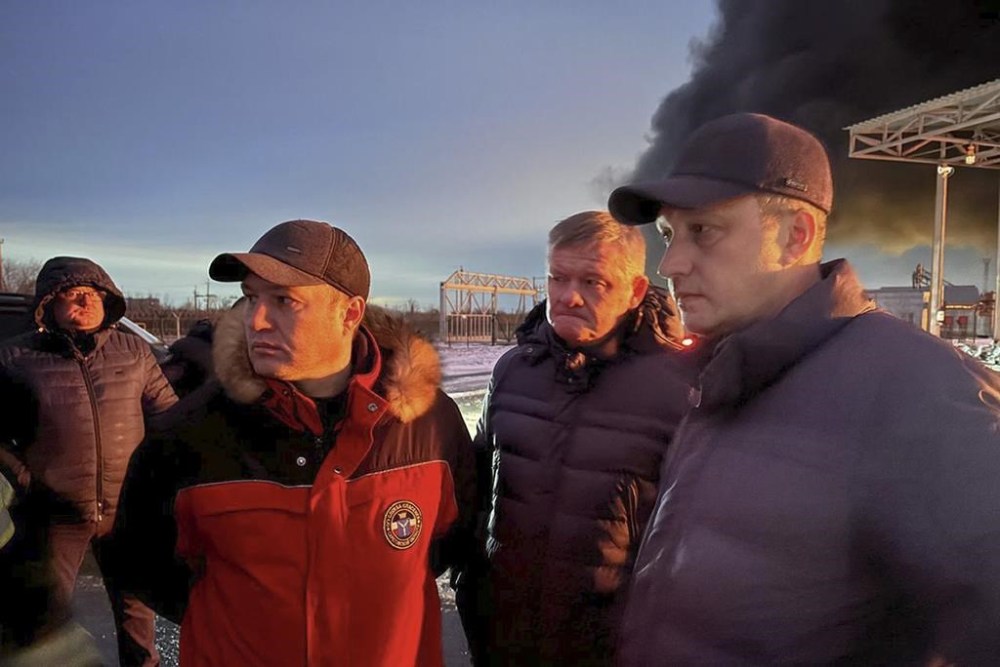 In this photo released by Governor of the Saratov region Roman Busargin telegram channel on Wednesday, Jan. 8, 2025, Governor of the Saratov region Roman Busargin, right, speaks to firefighters and rescuers at the industrial side damaged after Ukrainian drones' attack in Saratov, Russia. (Governor of the Saratov region Roman Busargin telegram channel via AP)