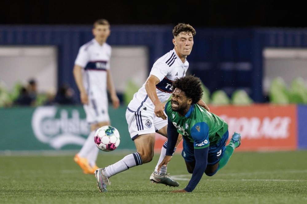 York United FC forward Brian Wright (9) tumbles as he battles for the ball with Vancouver Whitecaps midfielder Sebastian Berhalter (16) during the second half of Canadian Championship quarterfinal soccer game in Toronto on Wednesday, May 10, 2023. Forge FC has signed Canadian striker Wright to a multi-year contract, the Canadian Premier League team said Wednesday.THE CANADIAN PRESS/Cole Burston