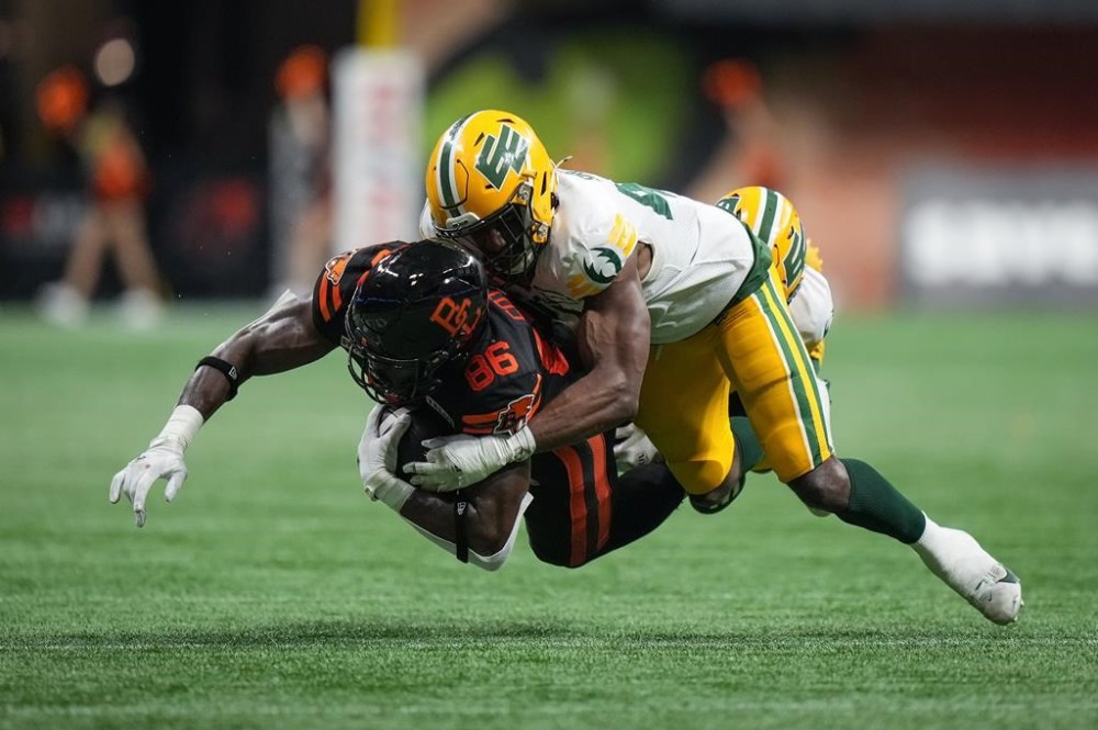 B.C. Lions' Jevon Cottoy (86) is tackled by Edmonton Elks' Elliott Brown after making a reception during the second half of a CFL football game, in Vancouver, on Thursday, June 27, 2024. The Edmonton Elks have released American defensive lineman Elliott Brown for him to pursue NFL opportunities.THE CANADIAN PRESS/Darryl Dyck