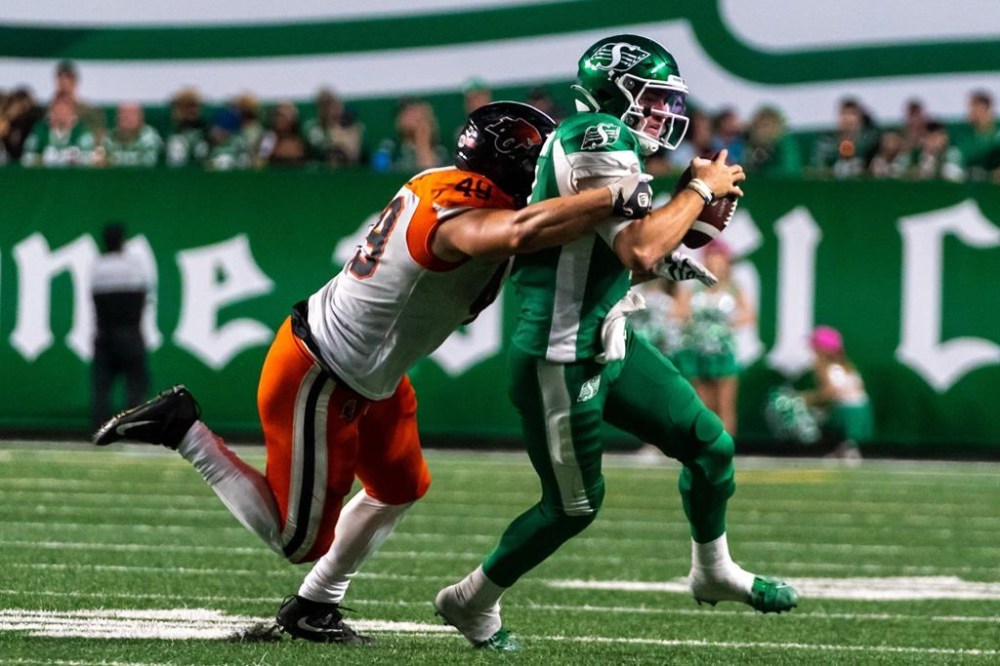 B.C. Lions defensive lineman Tibo Debaillie (49) tackles Saskatchewan Roughriders quarterback Cody Fajardo (7) during the third quarter of CFL football action in Regina, on Friday, July 29, 2022. THE CANADIAN PRESS/Heywood Yu