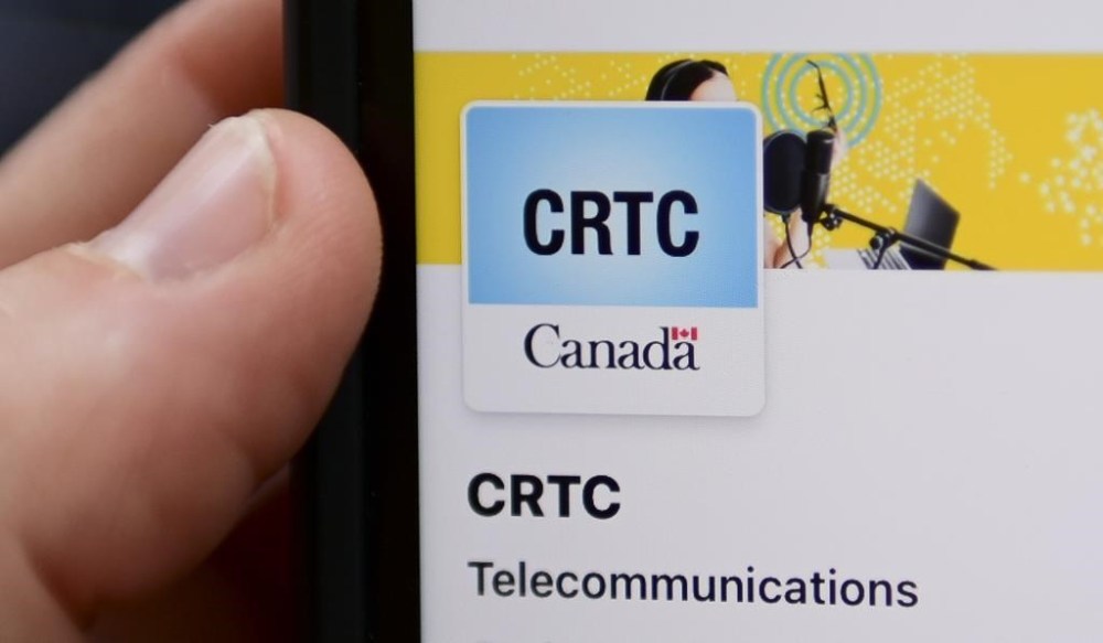 A person navigates to the on-line social-media pages of the Canadian Radio-television and Telecommunications Commission (CRTC) on a cell phone in Ottawa on May 17, 2021. THE CANADIAN PRESS/Sean Kilpatrick