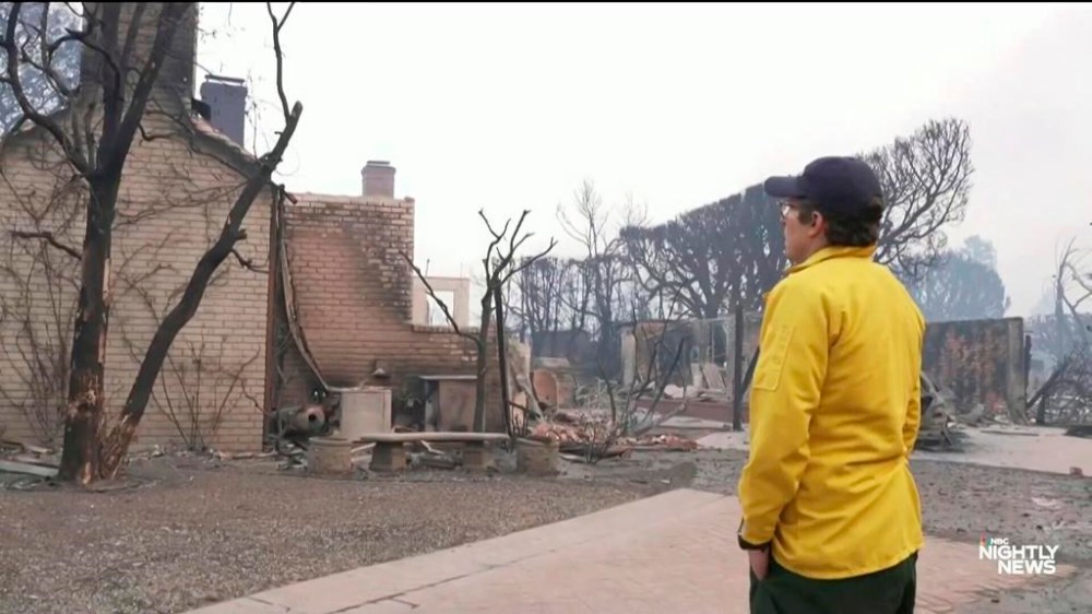 This image provided by NBC shows reporter Jacob Soboroff in front of the burnt-out home where grew up in Pacific Palisades, Calif., Wednesday, Jan. 8, 2025. (NBC via AP)
