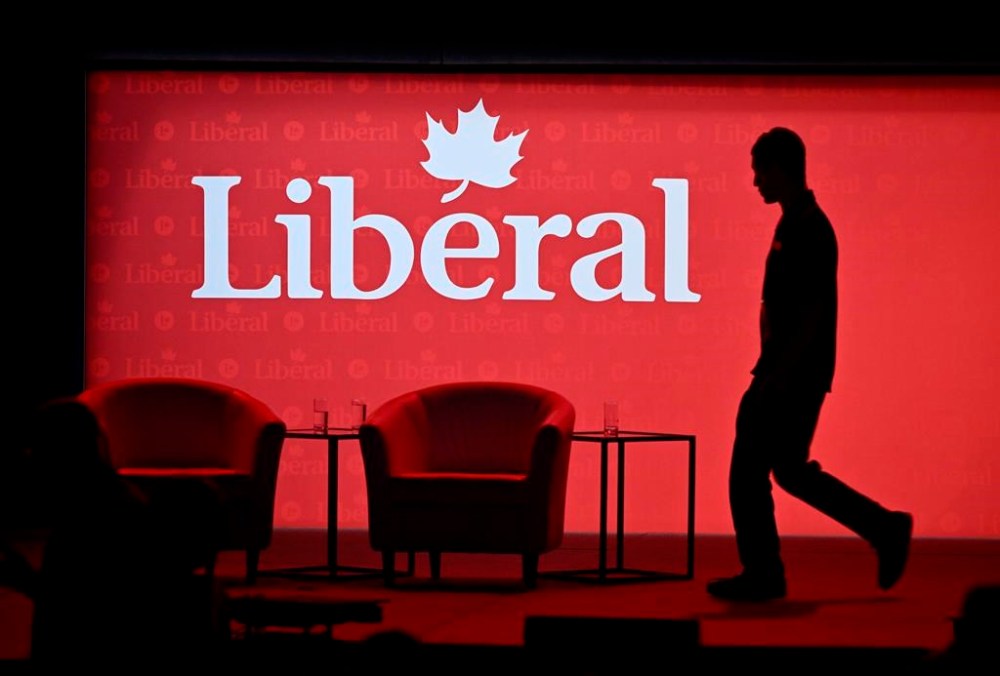 A stagehand works on the stage in between presenters at the 2023 Liberal National Convention in Ottawa, on Thursday, May 4, 2023. THE CANADIAN PRESS/Justin Tang