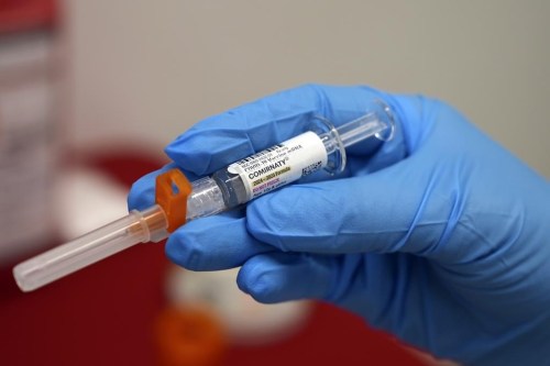 The Public Health Agency of Canada says federal funding for COVID-19 vaccines will stop this year and the provinces and territories will be responsible for buying them and determining the timing of the vaccinations. A pharmacist holds a COVID-19 vaccine at a pharmacy in New York, on Tuesday, Sept. 24, 2024. THE CANADIAN PRESS/AP-Mary Conlon