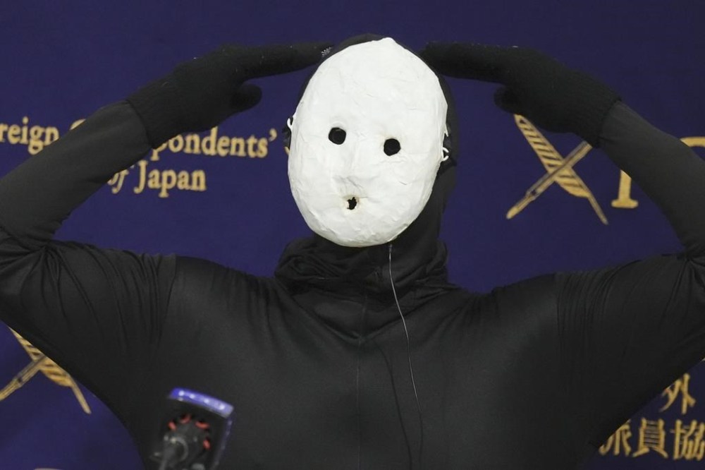 Uketsu, a Japanese YouTuber and horror author poses at his media conference at the Foreign Correspondents' Club of Japan, Thursday, Jan. 16, 2025, in Tokyo. (AP Photo/Eugene Hoshiko)