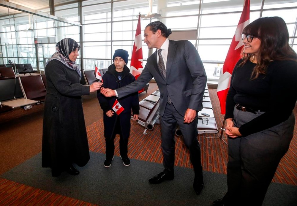 Manitoba Premier Wab Kinew and his wife Dr. Lisa Monkman welcome a Palestinian mother and her son from Gaza to Winnipeg, Manitoba at the Winnipeg Airport Thursday, Jan. 16, 2025. Manitoba is hosting the mother and her son and providing complex health care for the boy. THE CANADIAN PRESS/John Woods