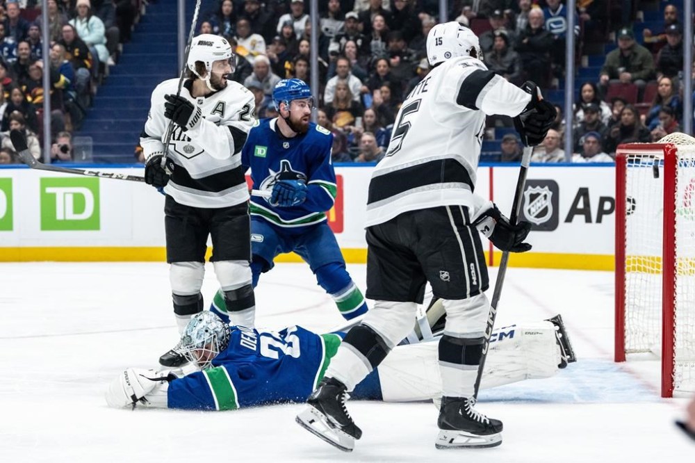 Los Angeles Kings' Alex Turcotte (15) scores on Vancouver Canucks goaltender Thatcher Demko (35) as Filip Hronek (17) and Los Angeles' Phillip Danault (24) watch during the first period of an NHL hockey game in Vancouver, on Thursday, January 16, 2025. THE CANADIAN PRESS/Ethan Cairns
