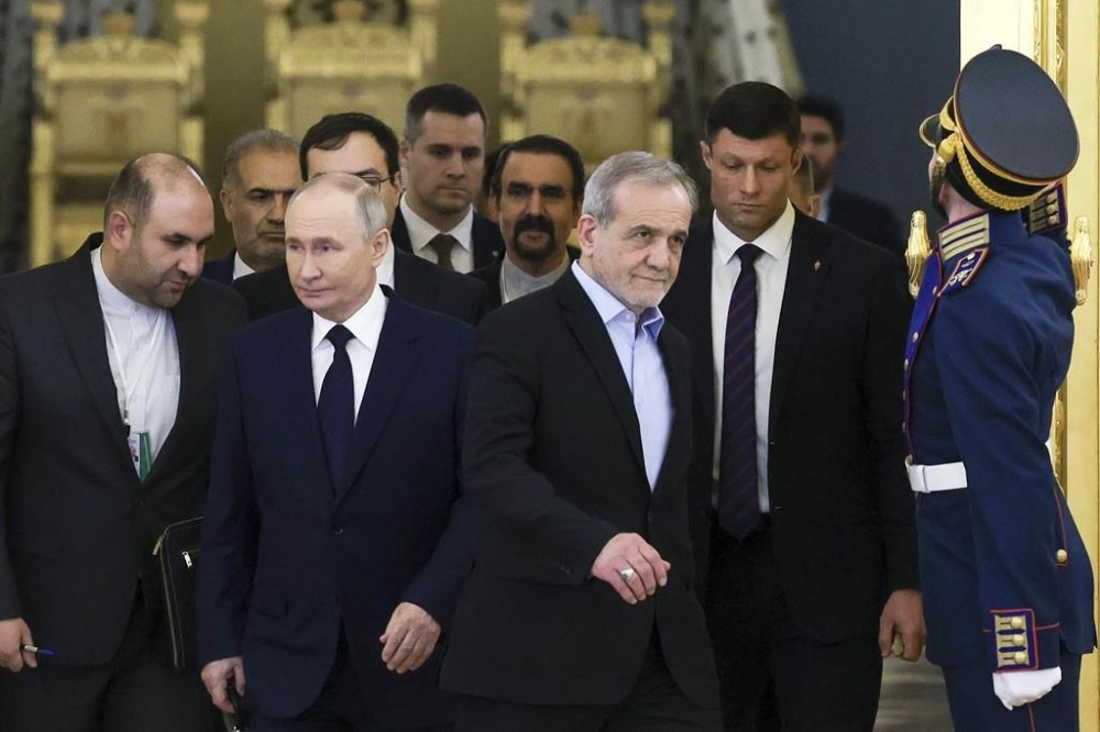 Russian President Vladimir Putin, second left, and Iranian President Masoud Pezeshkian, second right, arrive to attend a meeting in an expanded format at the Kremlin in Moscow, Russia, Friday, Jan. 17, 2025. (Vyacheslav Prokofyev, Sputnik, Kremlin Pool Photo via AP)