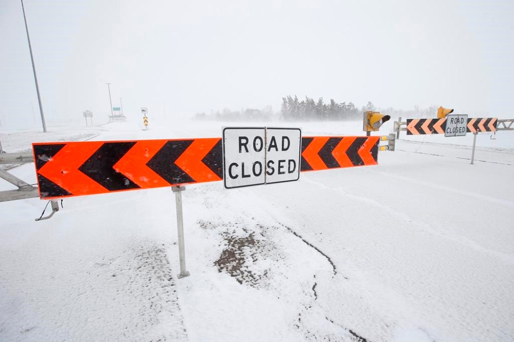The Manitoba government is urging drivers to avoid all roadways in southern Manitoba as storm conditions have made visibility near zero in certain areas. The Trans Canada highway was closed as the city wakes up to a snowstorm in Winnipeg, Wednesday, April 13, 2022. THE CANADIAN PRESS/John Woods