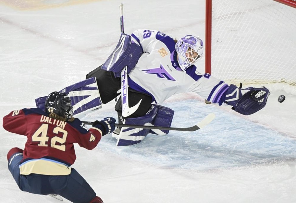 Montreal Victoire's Claire Dalton (42) scores against Minnesota Frost goaltender Nicole Hensley during second period PWHL hockey action in Laval, Que., Friday, January 17, 2025. THE CANADIAN PRESS/Graham Hughes