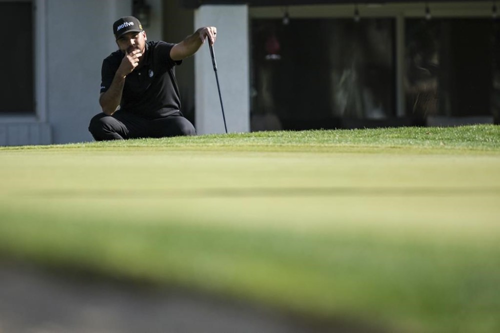Jason Day waits to putt on the fourth green at La Quinta Country Club Course during the first round of the American Express golf tournament in La Quinta, Calif., Thursday, Jan. 16, 2025. (AP Photo/William Liang)