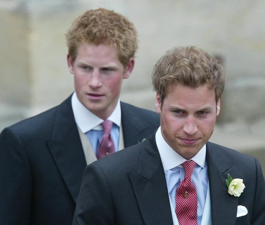 FILE - Britain's Prince William, right, and Prince Harry after the marriage of their father Britain's Prince Charles, the Prince of Wales, and his wife Camilla, the Duchess of Cornwall, at the Guildhall in Windsor, England, after their civil wedding ceremony, on April 9, 2005. (AP Photo/Dave Caulkin, File)