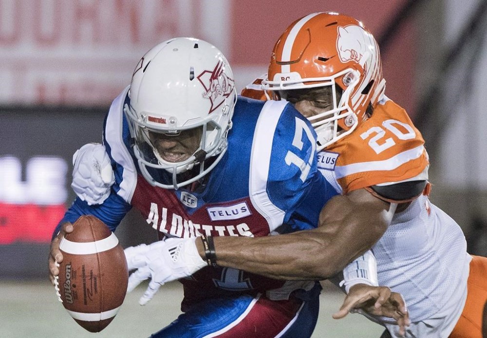 Montreal Alouettes quarterback Antonio Pipkin, left, is sacked by BC Lions Bo Lokombo during first half CFL football in Montreal, Friday, September 14, 2018. THE CANADIAN PRESS/Graham Hughes