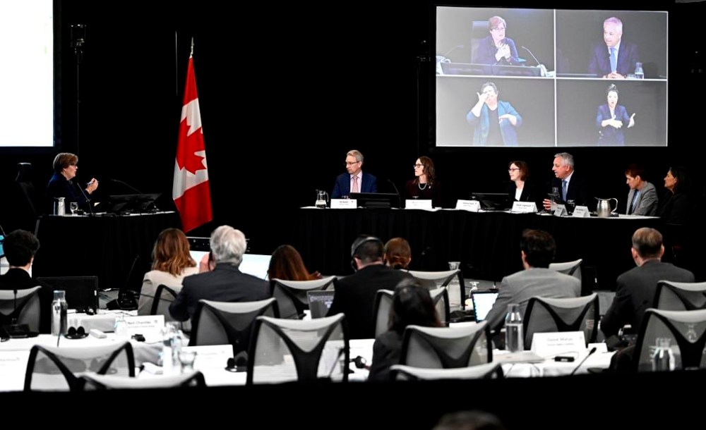 Commissioner Marie-Josee Hogue asks a question to David Vigneault, former director of the Canadian Security Intelligence Service, third from right, as CSIS representatives appear at the Foreign Interference Commission in Ottawa on Friday, Sept. 27, 2024. THE CANADIAN PRESS/Justin Tang
