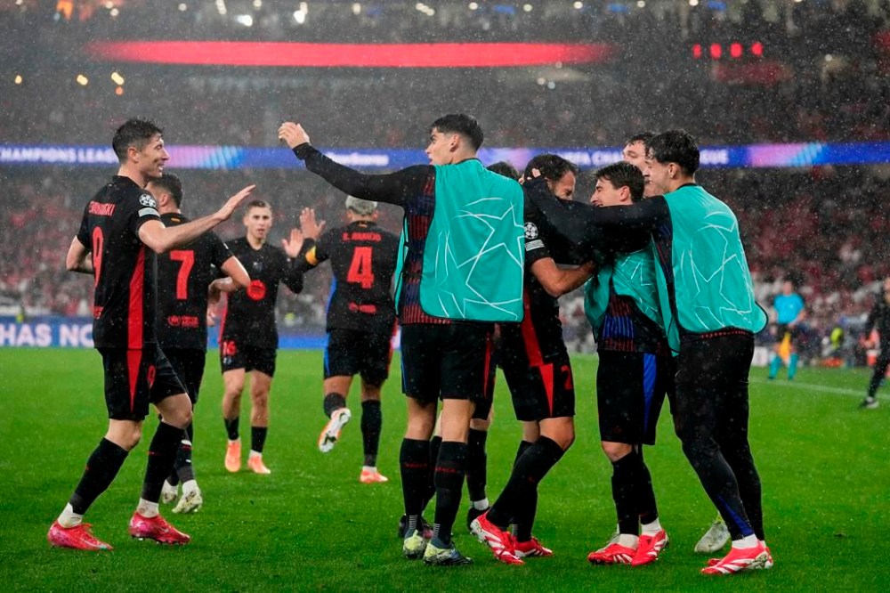 Barcelona celebrate their side's fourth goal during a Champions League opening phase soccer match between SL Benfica and FC Barcelona at the Luz stadium in Lisbon, Tuesday, Jan. 21, 2025. (AP Photo/Armando Franca)
