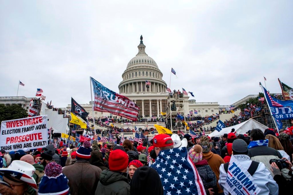 In this Jan. 6, 2021, file photo, insurrectionists loyal to President Donald Trump rally at the U.S. Capitol in Washington. An American man found guilty of rioting at the U.S. Capitol four years ago remains in custody in British Columbia even as he was given a presidential pardon for the crime. THE CANADIAN PRESS/AP, Jose Luis Magana