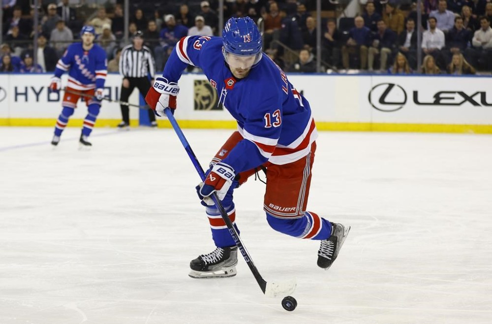 New York Rangers left wing Alexis Lafrenière (13) skates with the puck against the Ottawa Senators during the first period of an NHL hockey game, Tuesday, Jan. 21, 2025, in New York. (AP Photo/Noah K. Murray)