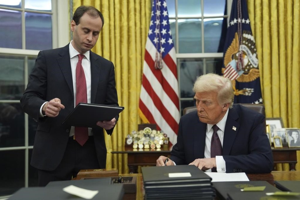 President Donald Trump signs an executive order in the Oval Office of the White House on Jan. 20. One of Trump's executive orders has taken aim at Transgender people. (The Canadian Press)