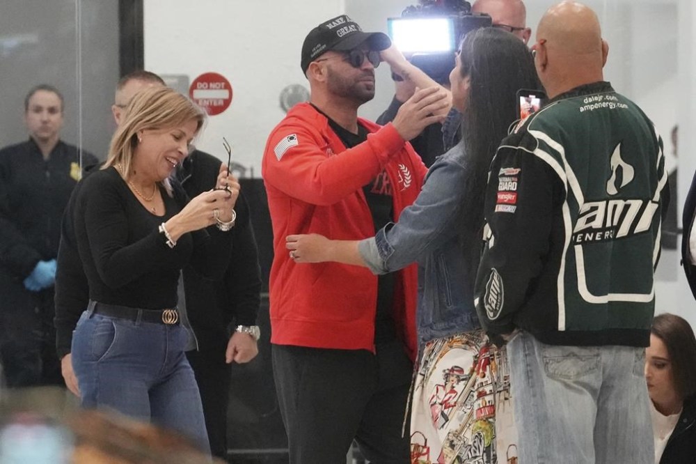 Enrique Tarrio hugs supporters after arriving at Miami International Airport, Wednesday, Jan. 22, 2025, in Miami. Tarrio was pardoned by President Donald Trump after he was convicted of seditious conspiracy for his role in the January 6 attack on the U.S. Capitol. (AP Photo/Marta Lavandier)