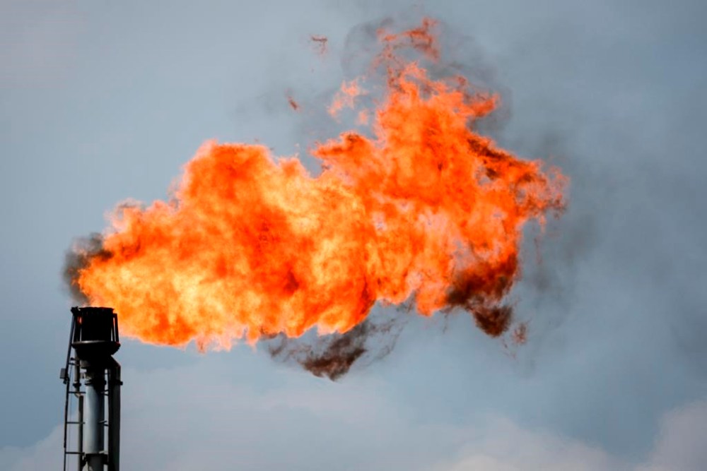 A flare stack burns off excess gas at a processing facility near Crossfield, Alta., June 13, 2023. THE CANADIAN PRESS/Jeff McIntosh